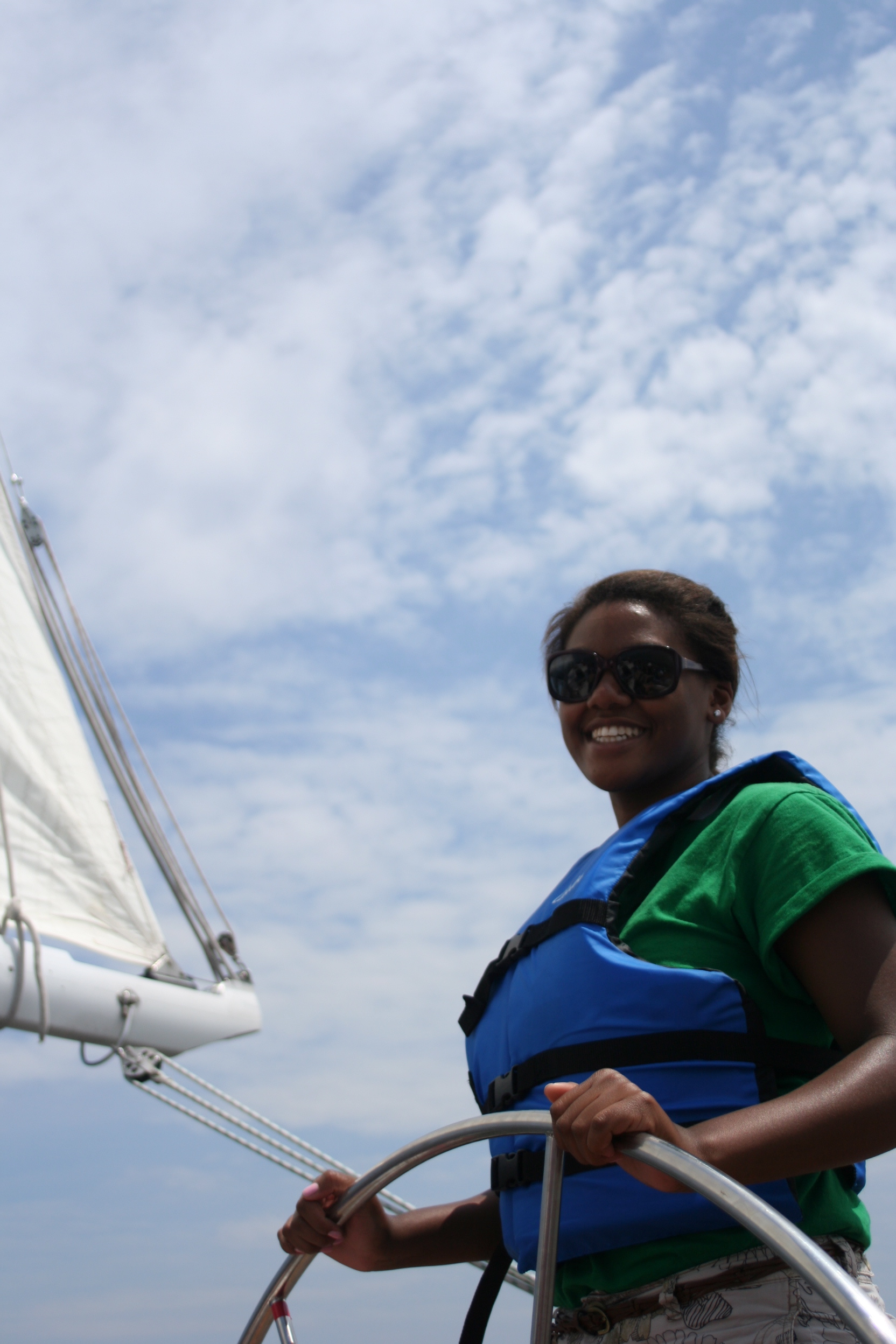 Smiling and sailing at the helm