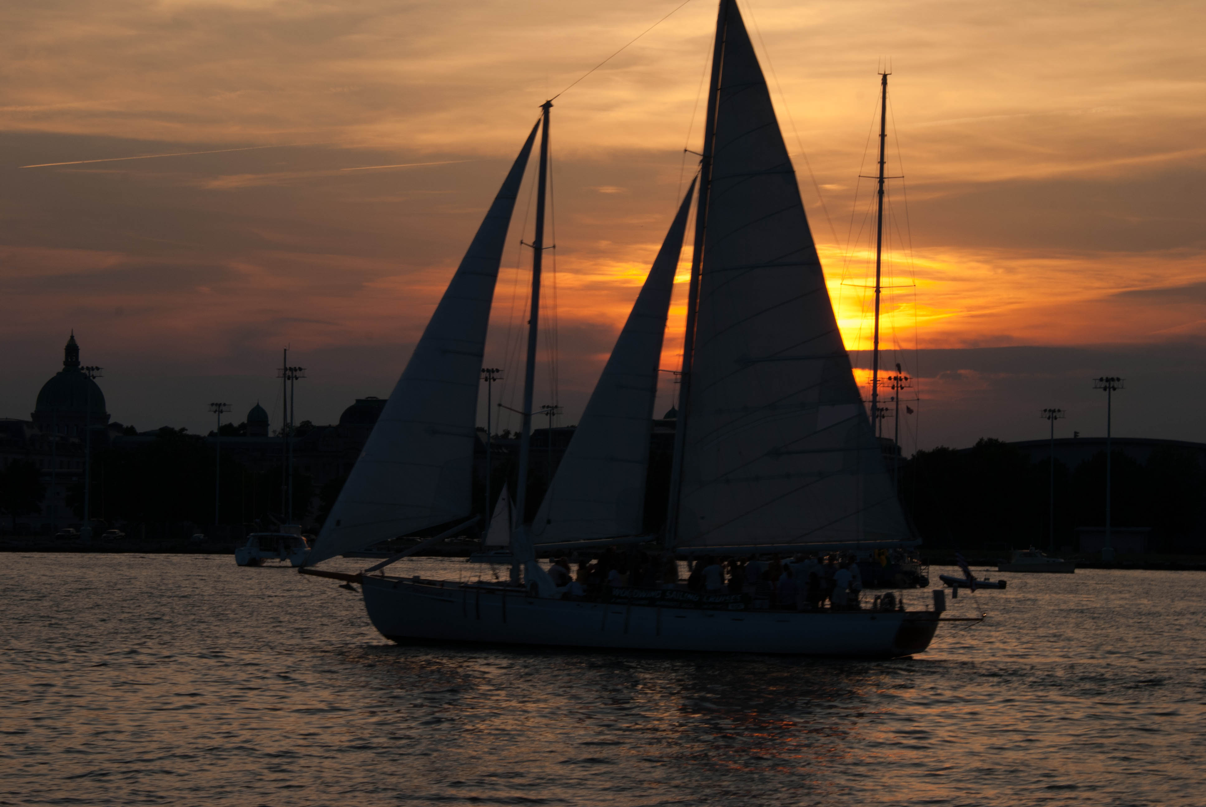 Schooner silhouetted by sunset and water