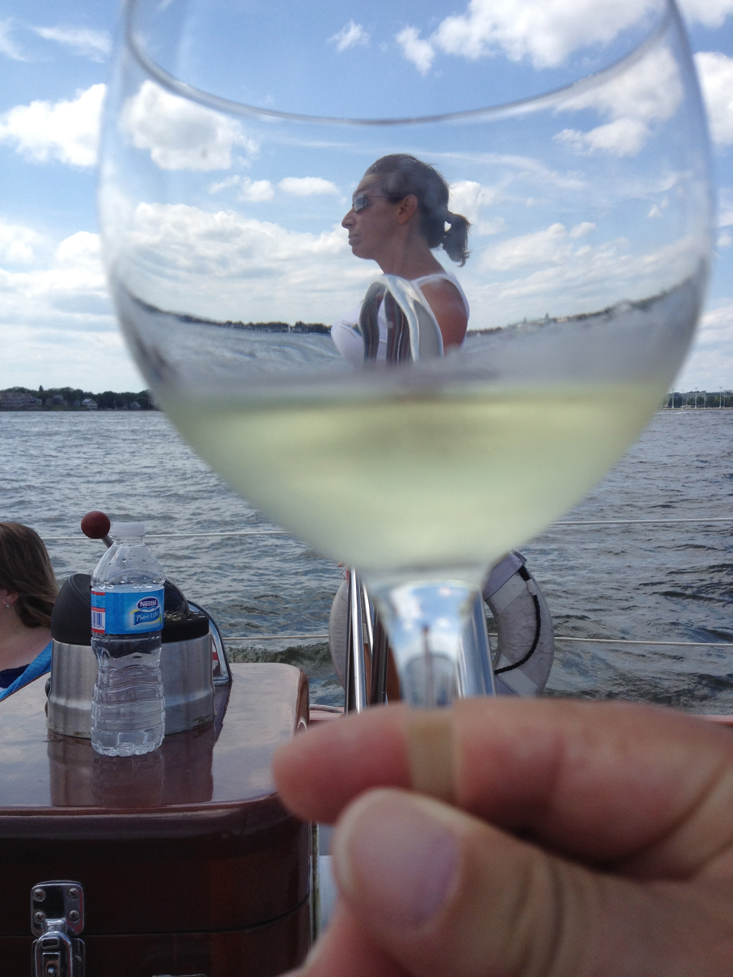 Glass of white wine looking through to Captain Jen