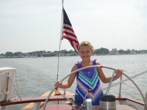 Captain Annie at the wheel of Schooner Woodwind
