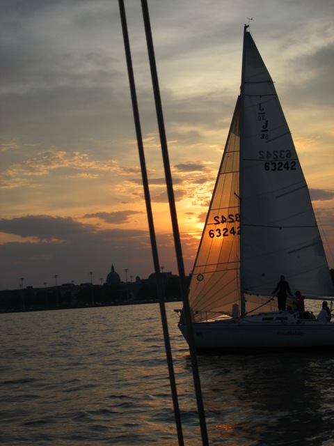 Sun shining through a sailboat sails