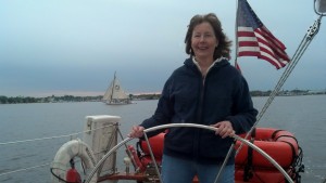 Mary at the helm.  Stanley Norman in background.