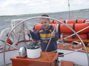 Captain Corbin steering the Schooner Woodwind