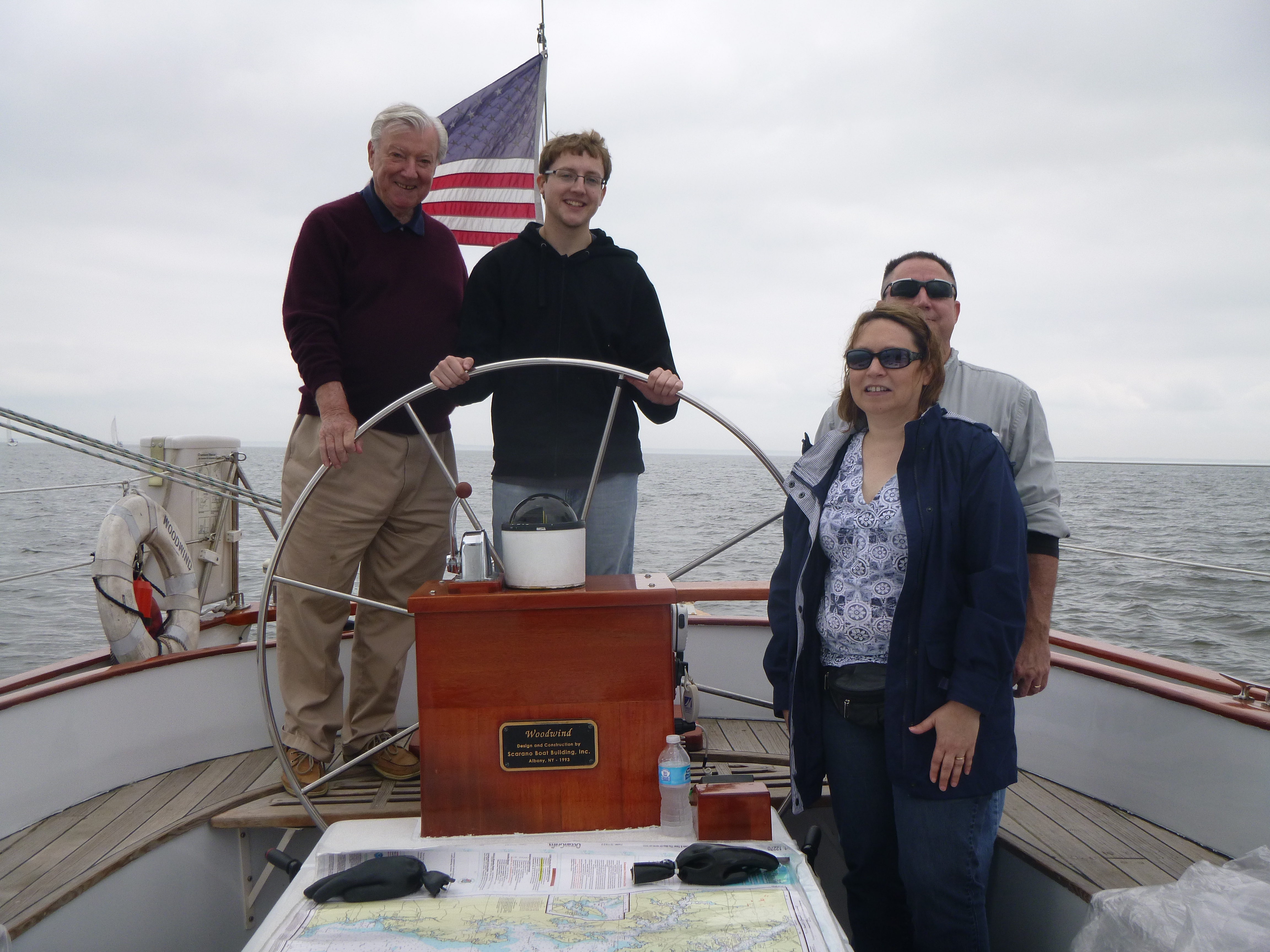 The Hannon Family aboard the Schooner Woodwind and steering the helm