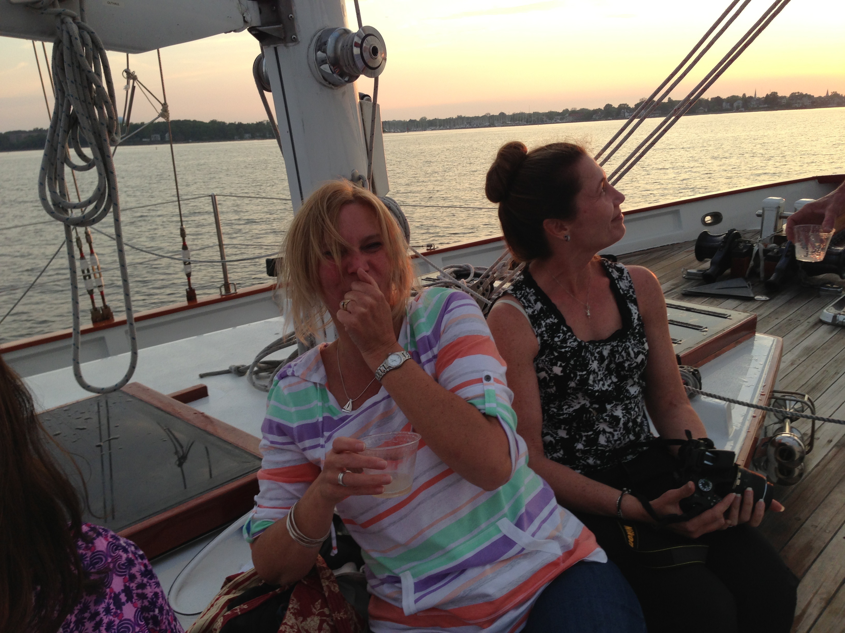 Guests enjoying beverages and a sunset sail