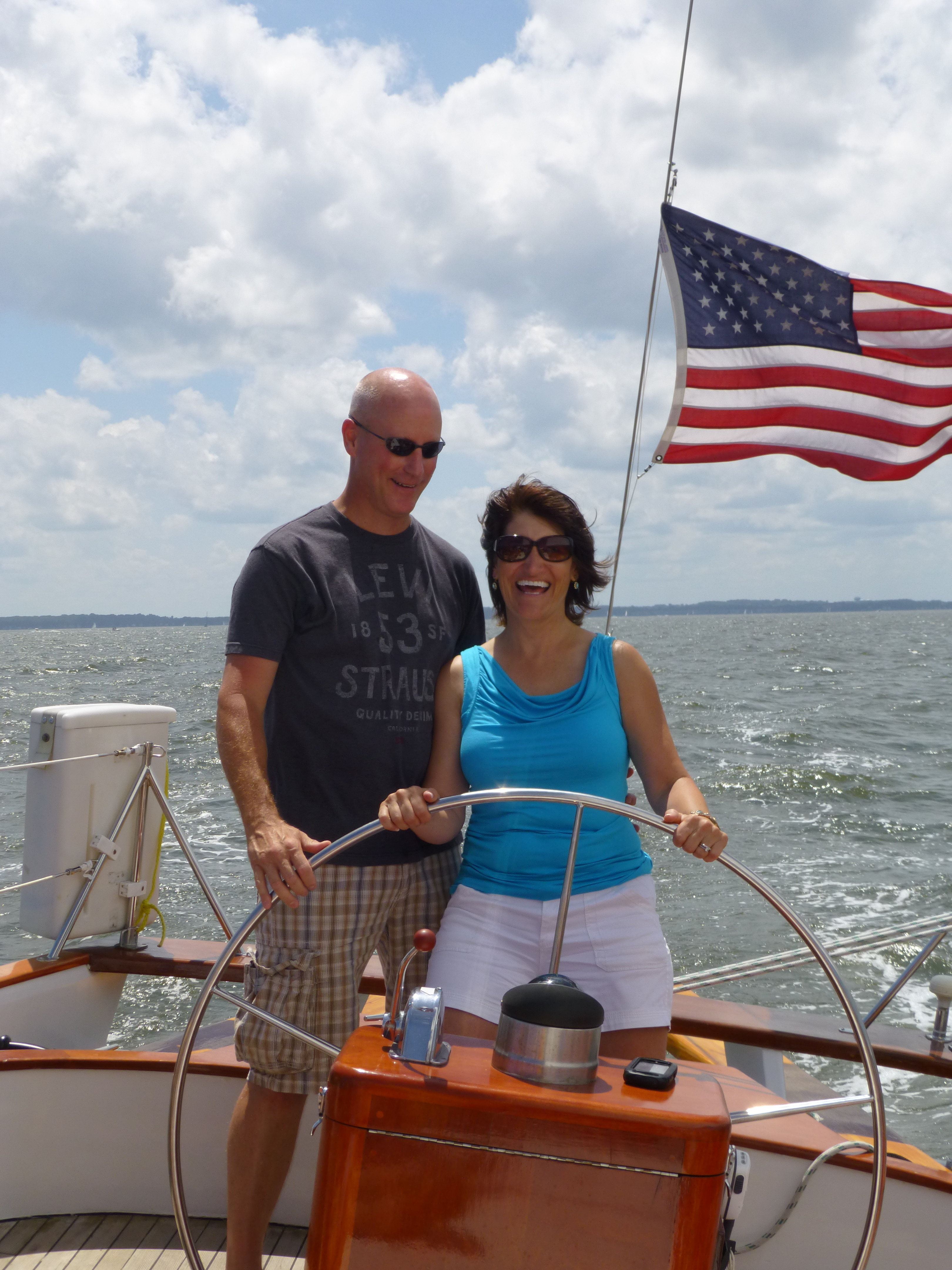 Donna & Scott Richardson sailing the schooner and smiling