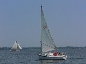 A Nonesuch catboat, with her distinctive wishbone boom and single sail on the right.  The Stanley Norman (on the left) was built in 1902 to dredge for oysters.  