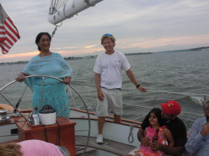 Nina at the helm with crew Chris looking on.  Her granddaughter took the helm later in the cruise. 