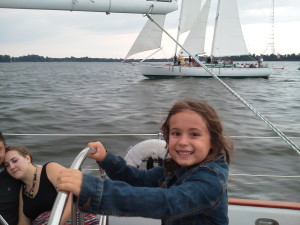 Millie sailing Woodwind II while "racing" Woodwind back into the harbor.