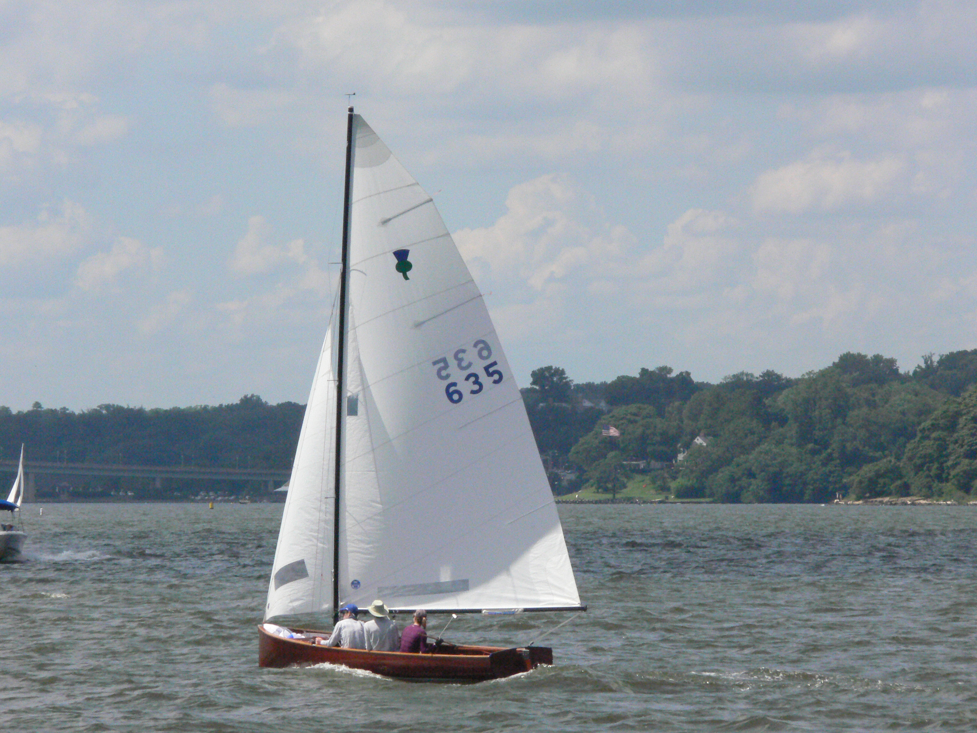 Wooden Sailboat sailing near the shcooner