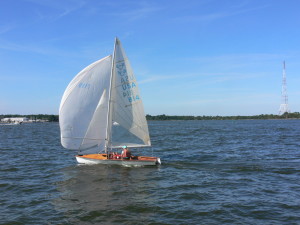 A 505 racing sloop flies into the harbor.