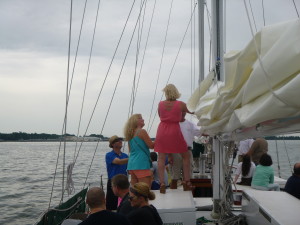 Scott's friends raising the mainsail on Schooner Woodwind