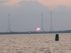 Sun setting between the radio towers at Greenbury Pt.