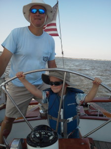 Mark shows his son Nate how to sail the Schooner Woodwind. A new crew-member in the making.