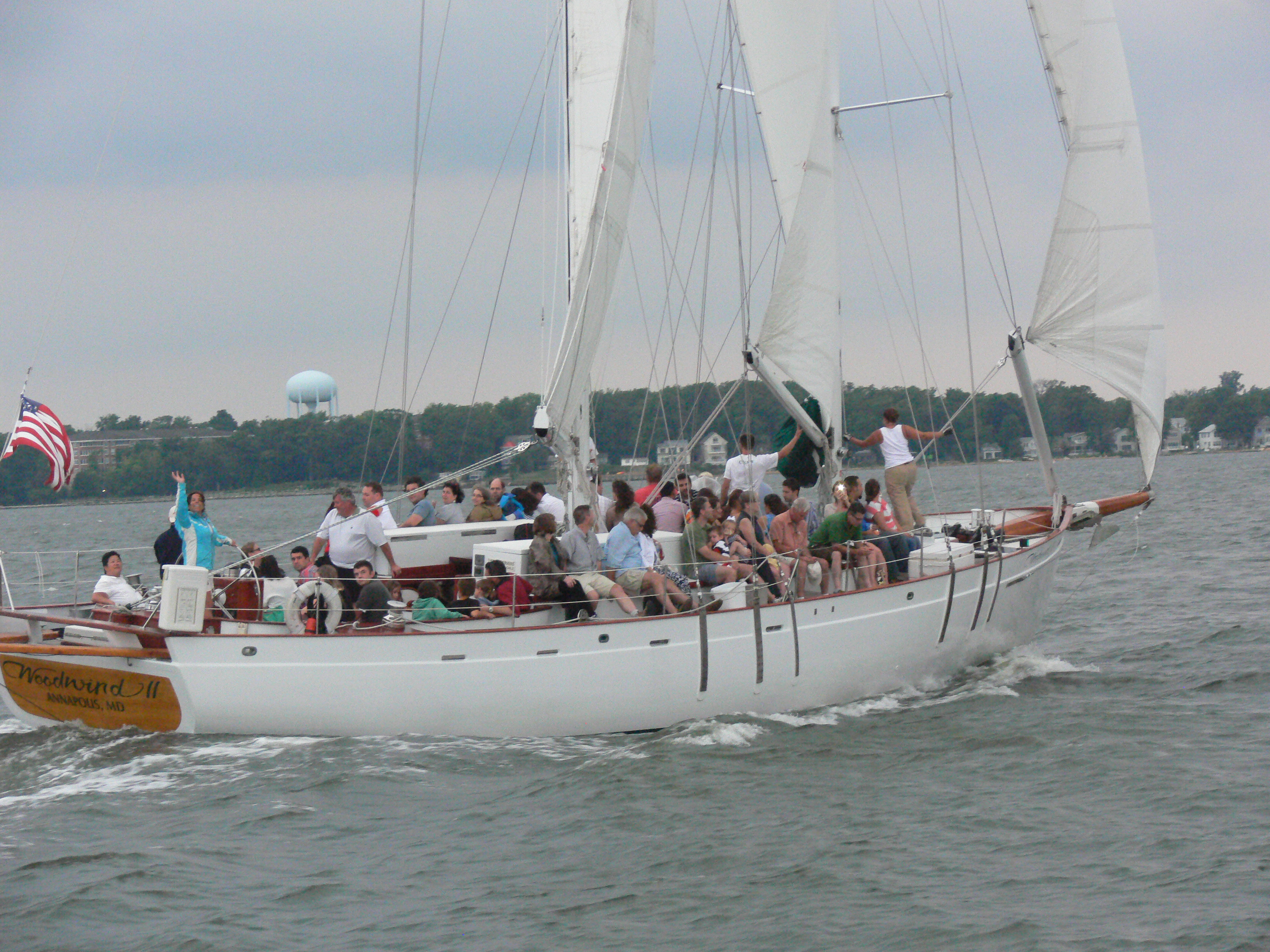 Captain Jen waves hello with a schooner full of guests