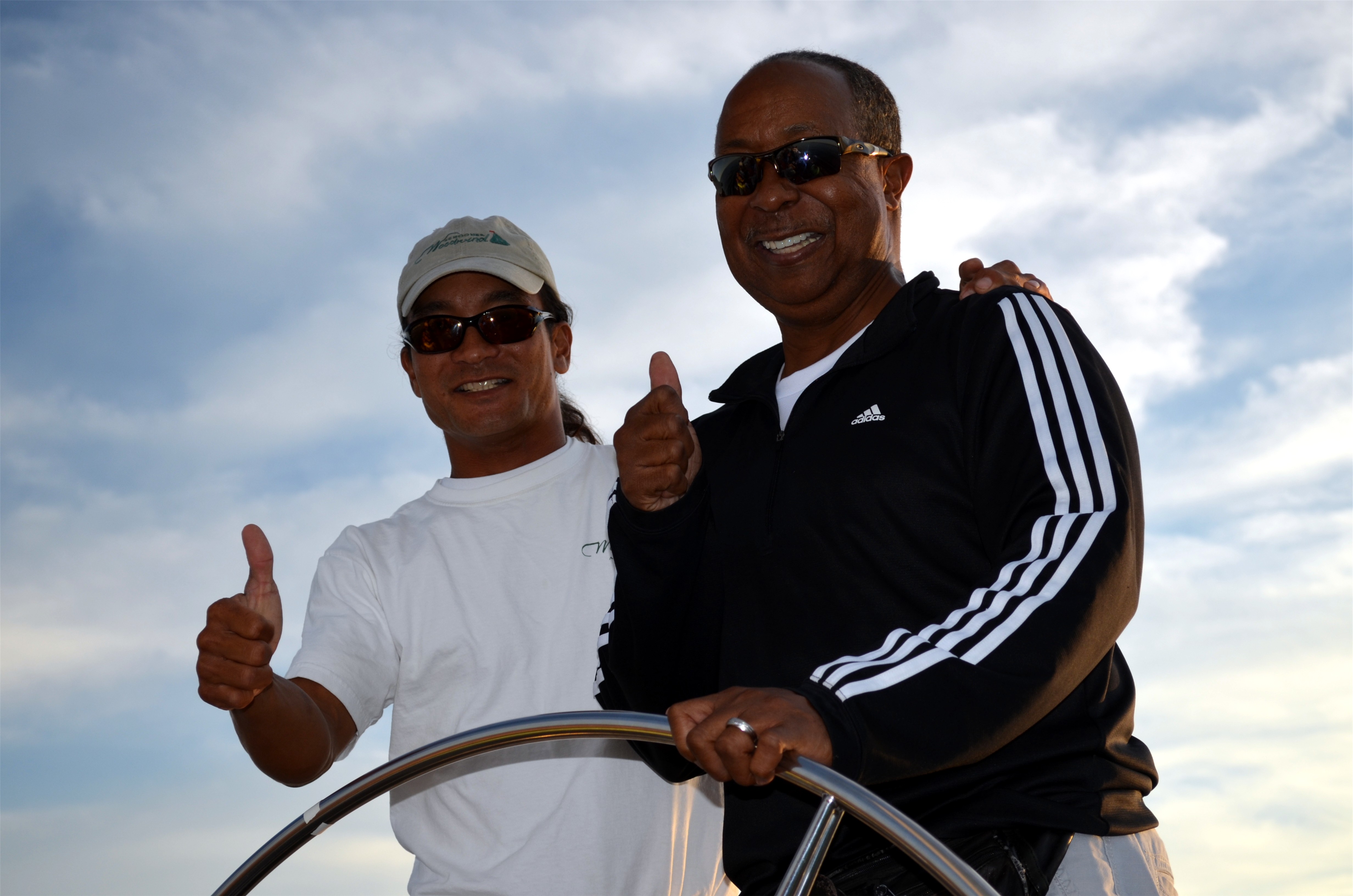 Guest and captain giving two thumbs up while sailing the Woodwind