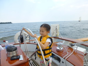 Girl Scout at the helm of Woodwind II