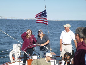 Charter guests at the wheel of Schooner Woodwind