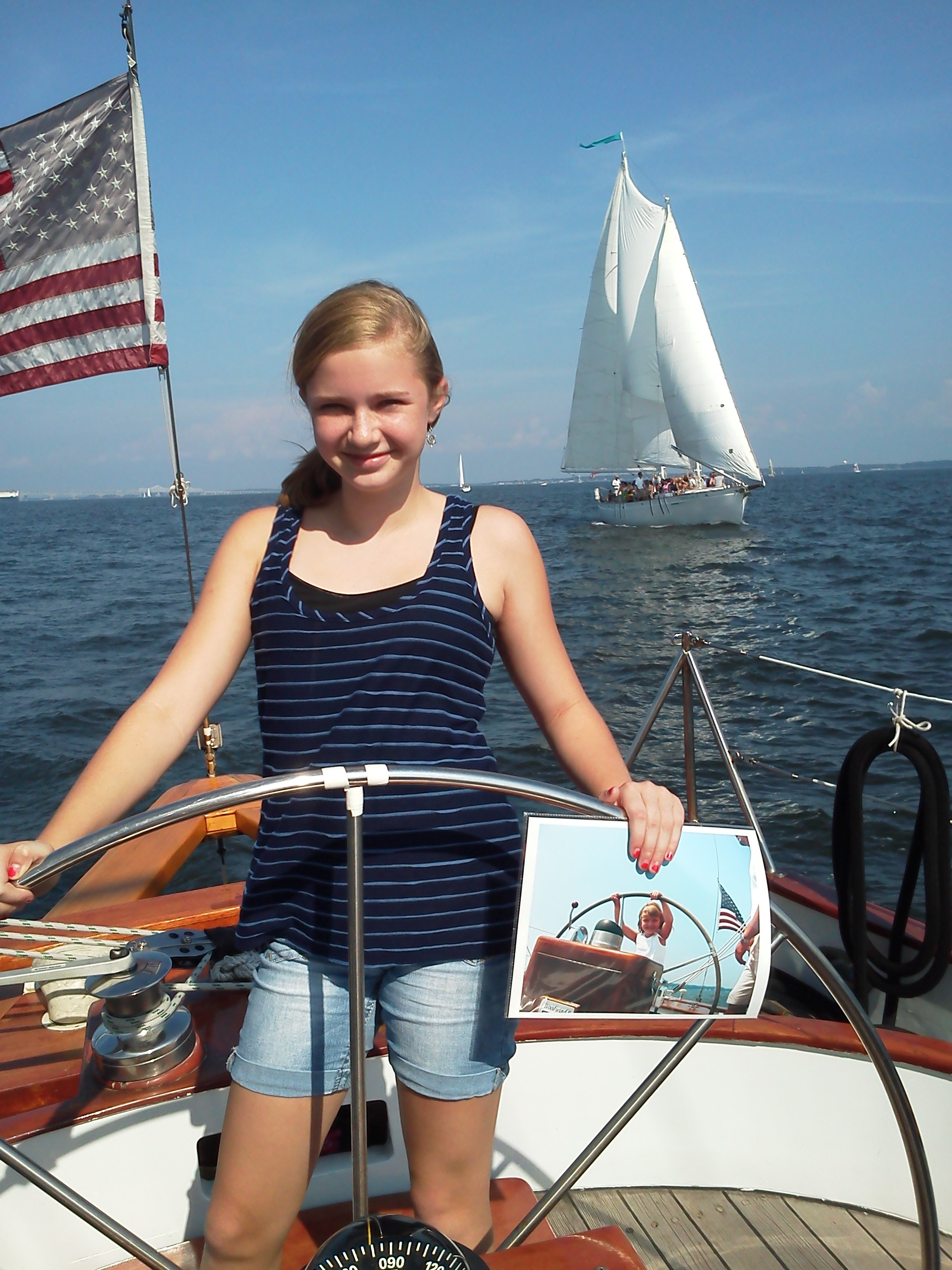 Sailing the Woodwind again. Holding up picture of when she was little and sailed