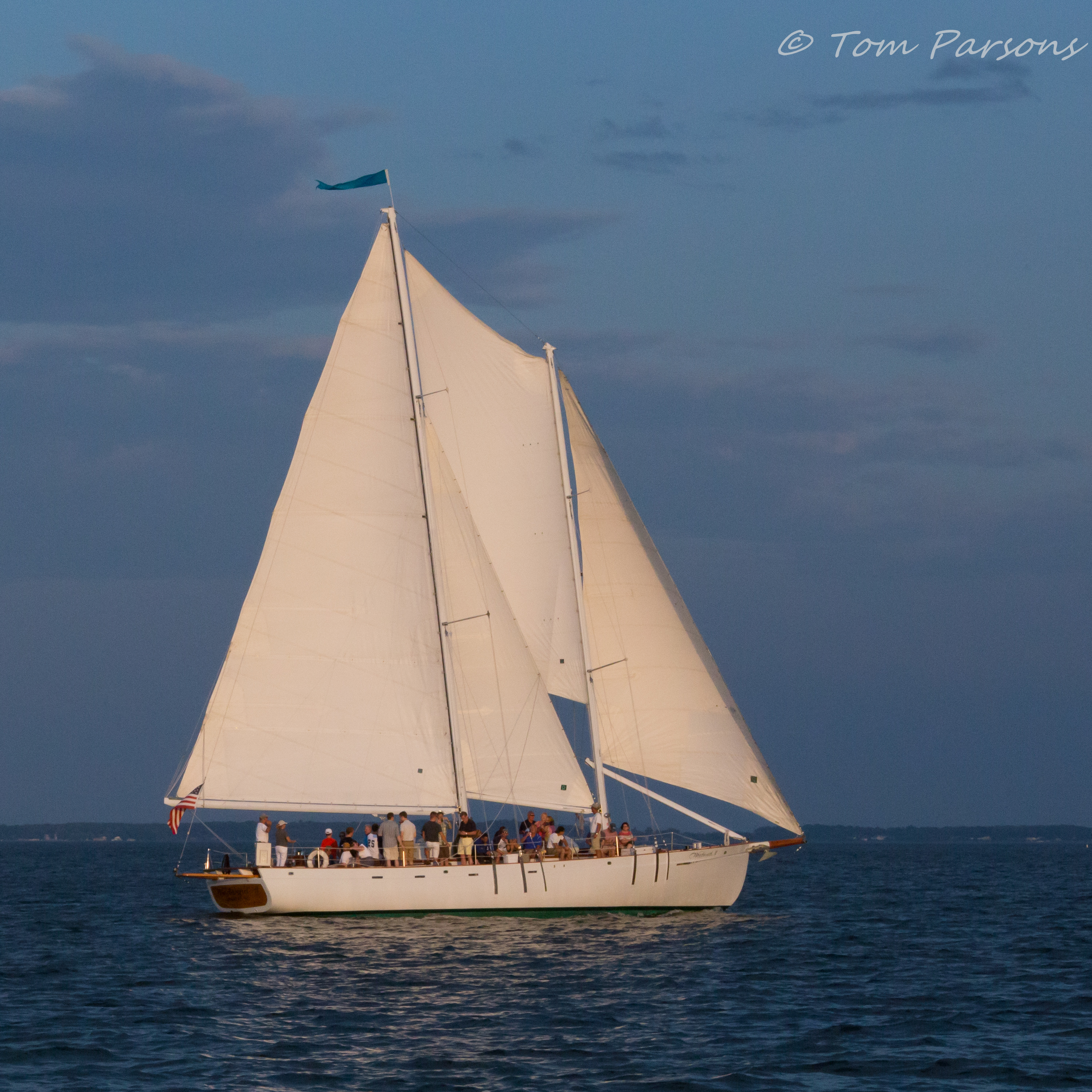 Beautiful White sails of the schooner against blue skies and water