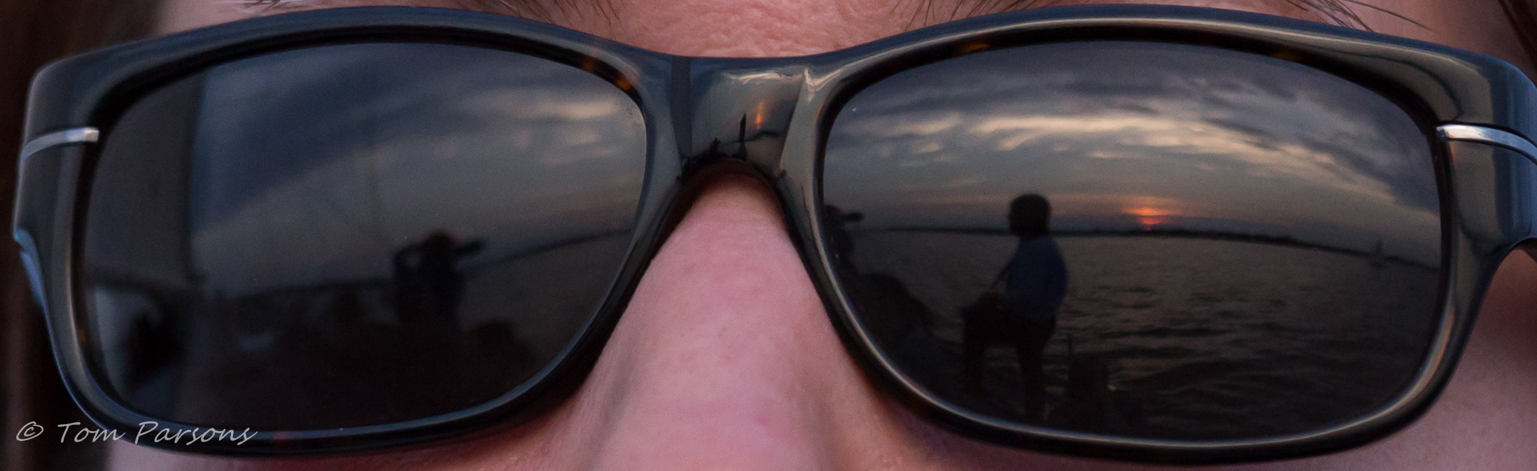 Sunglasses reflecting the sunset