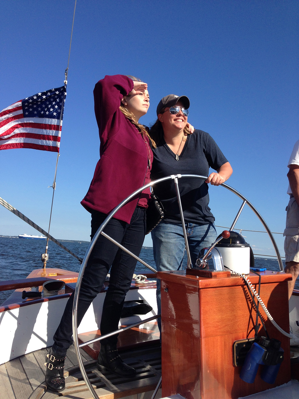 Two women steering the schooner and looking at which way to go