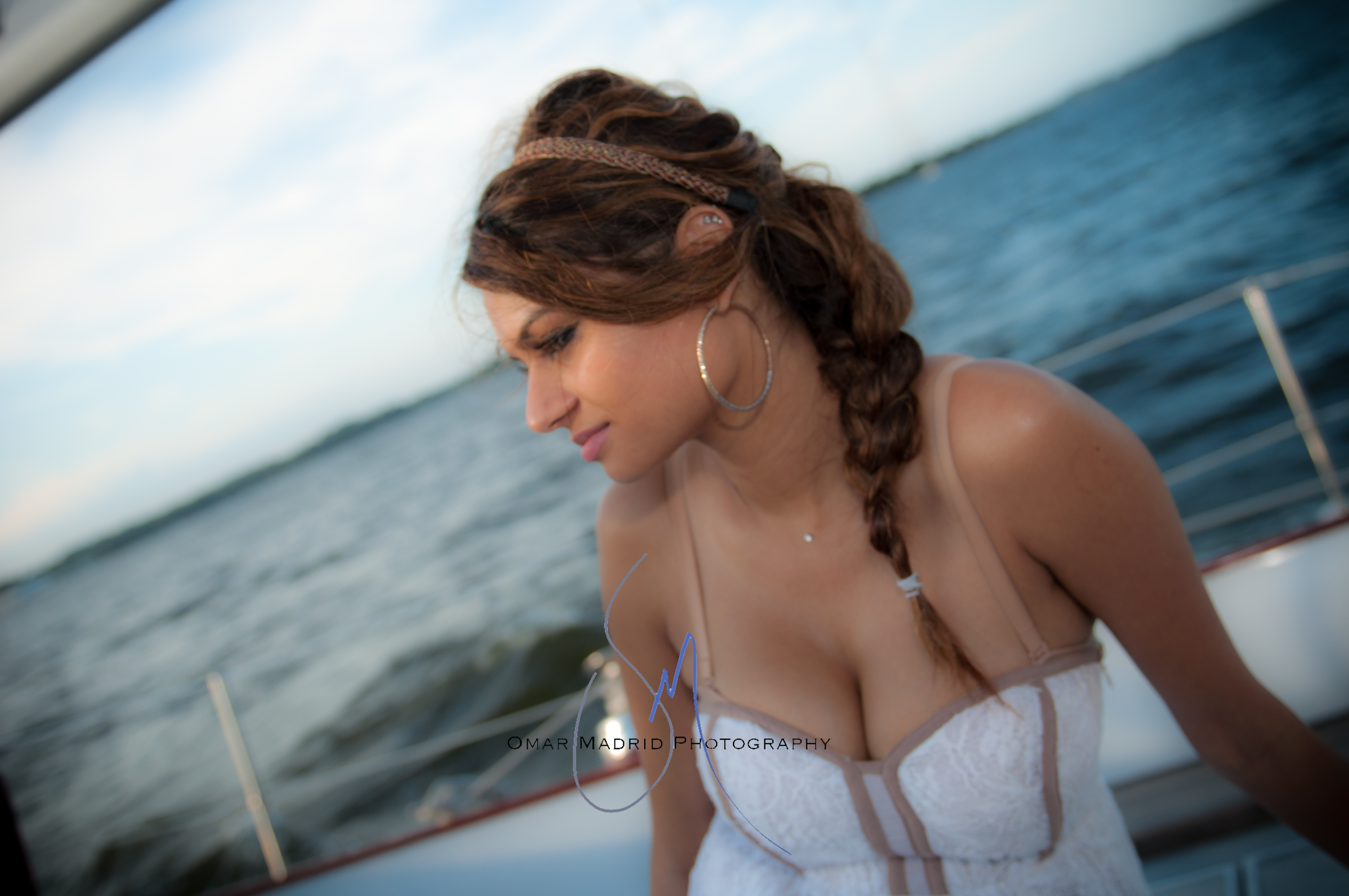 Beautiful young lady in a white dress sailing on the schooner