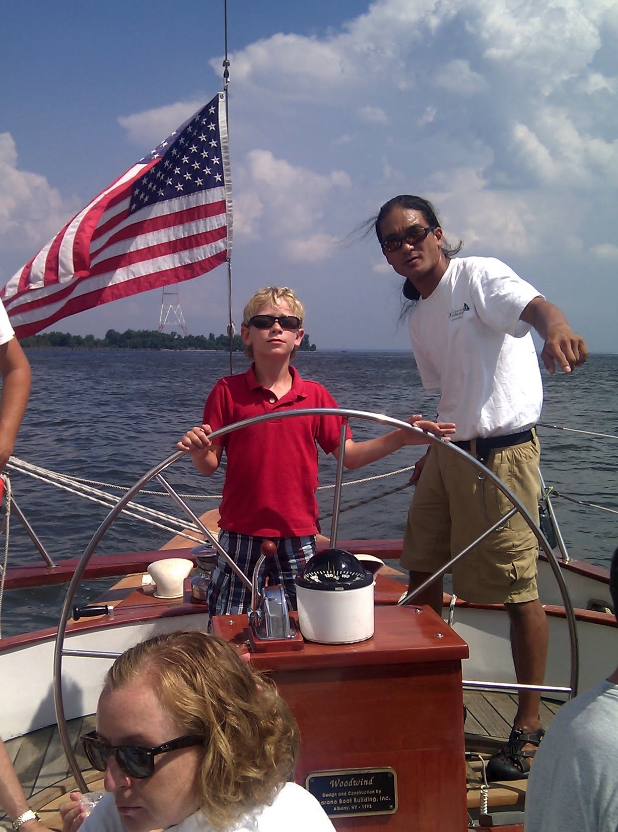 Young boy being shown which way to go by the captain of the boat