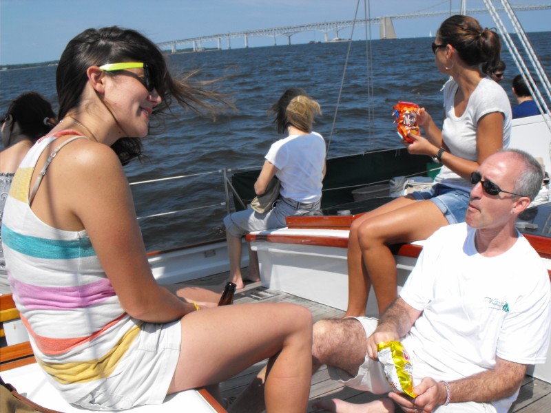 Guests enjoying snacks and a sail on a sunny day
