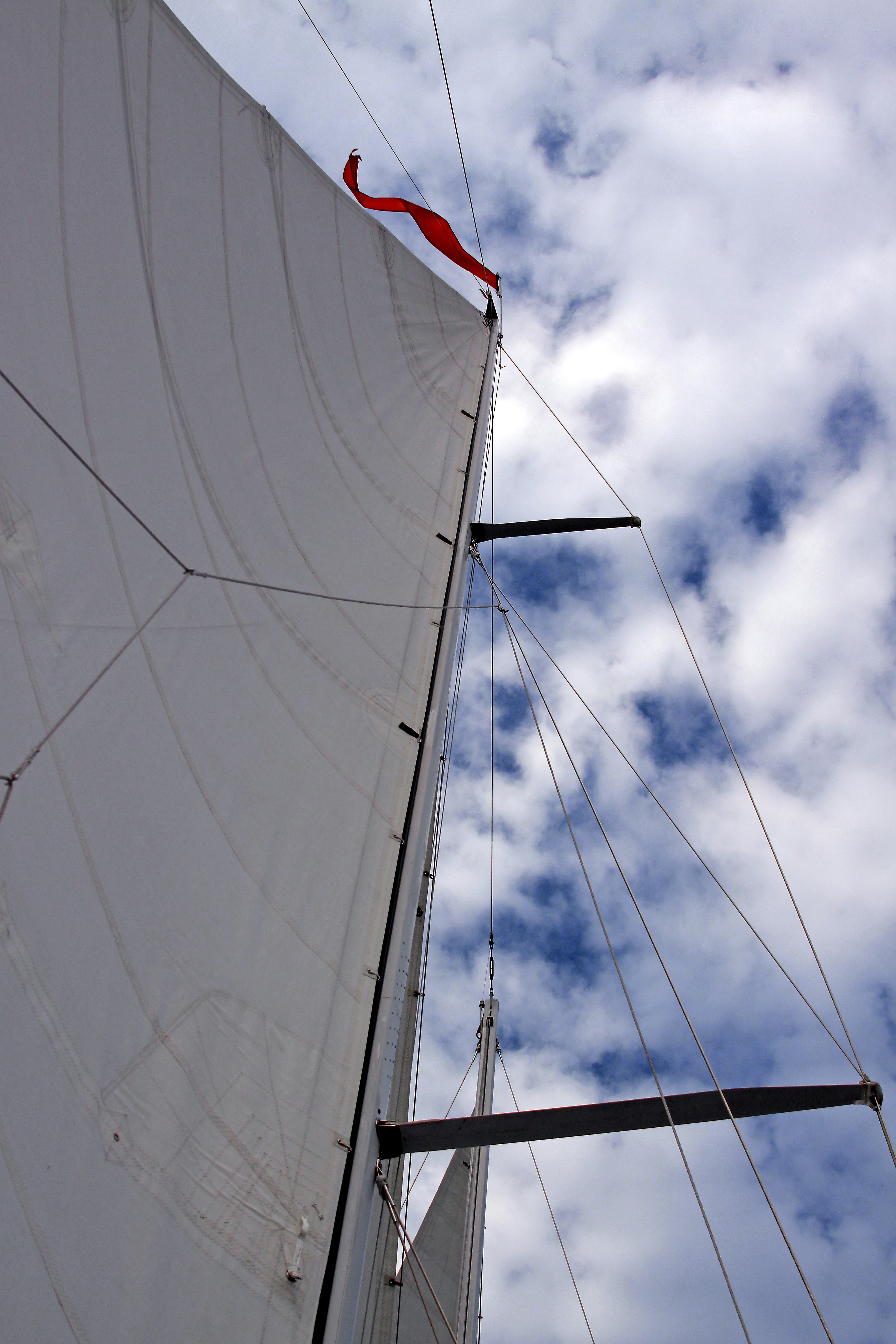White Sails and rigging with blue skies full of white clouds