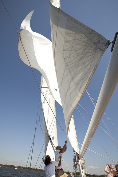 Raising the sails on a blue sky day