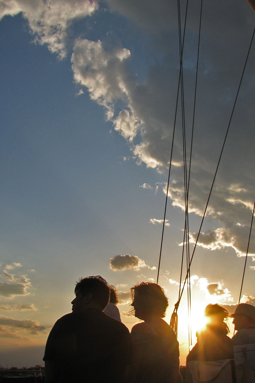 Guests enjoying a sunset over the bay from the schooner