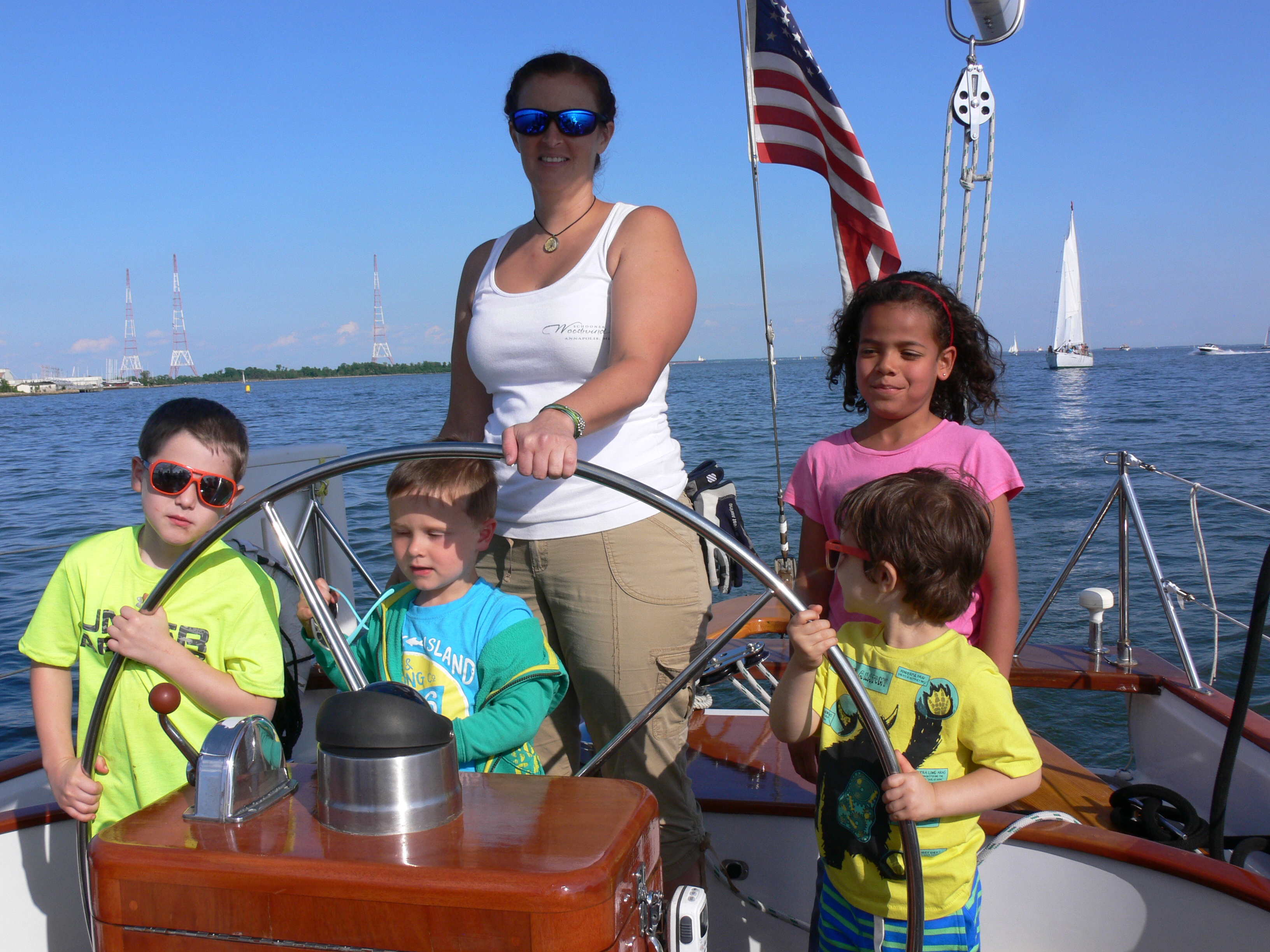 Women and four children steering the schooner