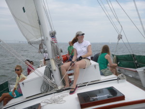 Melanie sheeting the staysail in the gusts