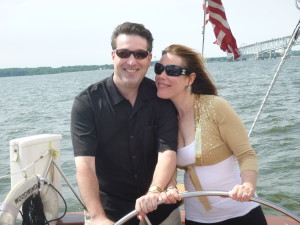 The newly engaged couple Dee and Dave sharing the wheel on the Schooner Woodwind 