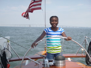 Nia at the wheel of the Schooner Woodwind II