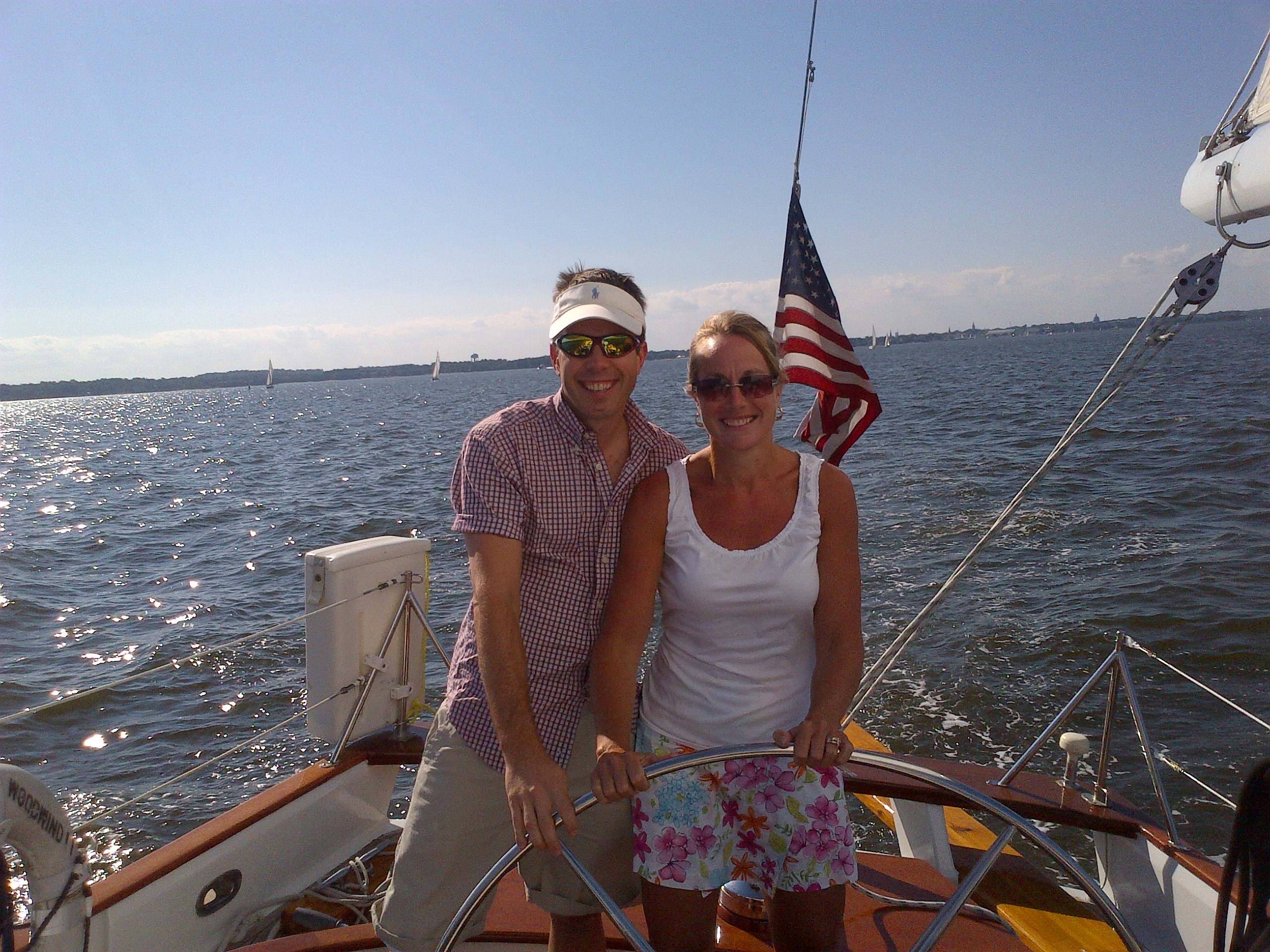 Man and women steering the schooner together