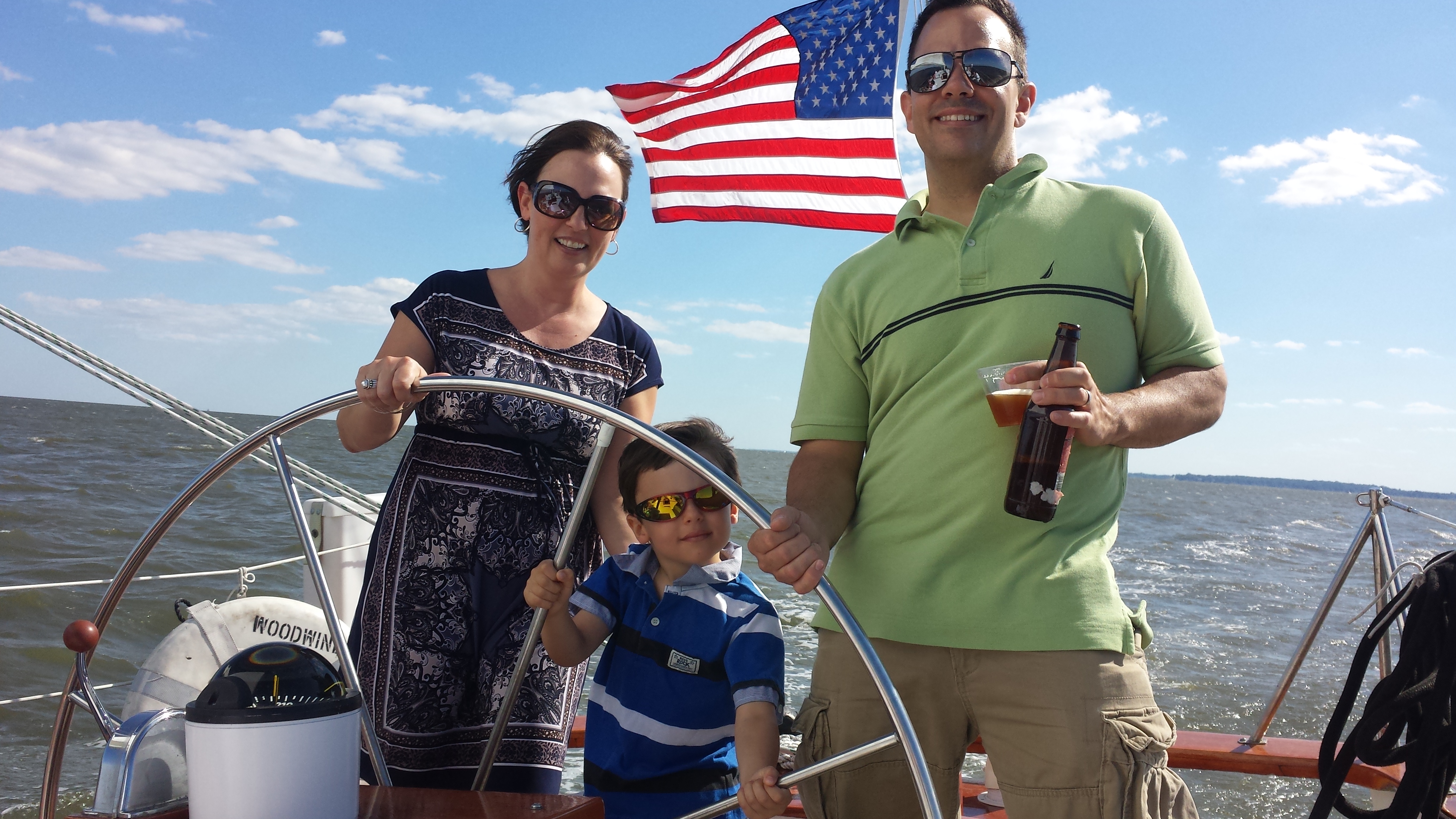 Family of three steering the schooner