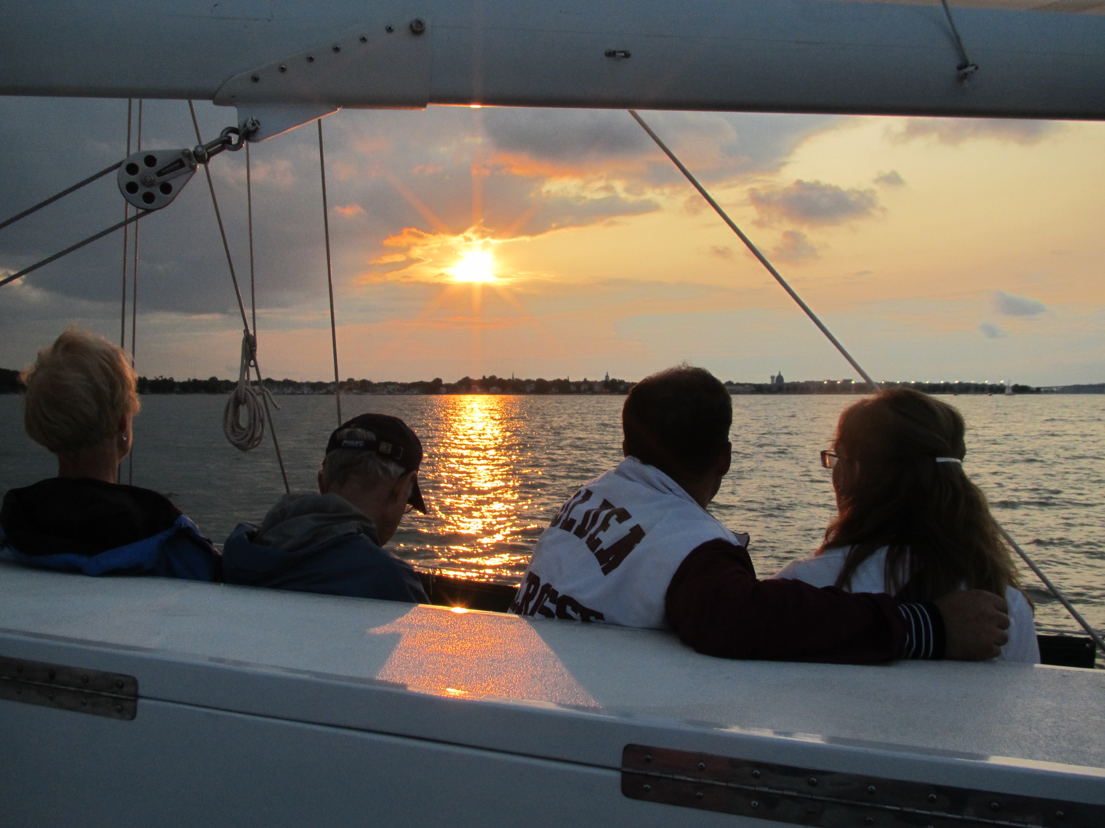 Two couples enjoying a sunset from the schooner while sailing