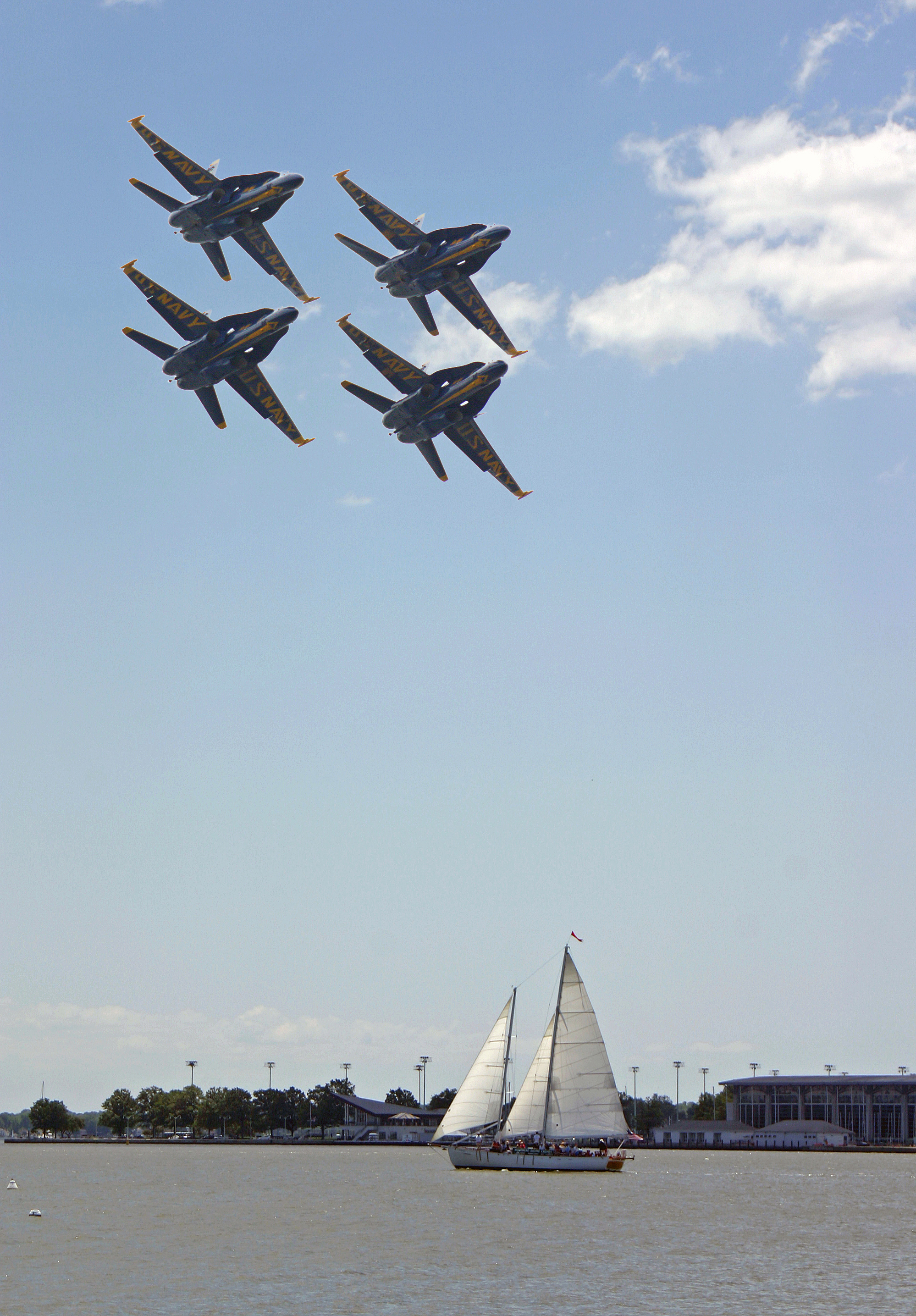 Four Blue Angel jets soaring over the schooner and water