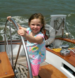 Lola, 5 years old, taking a turn at the helm