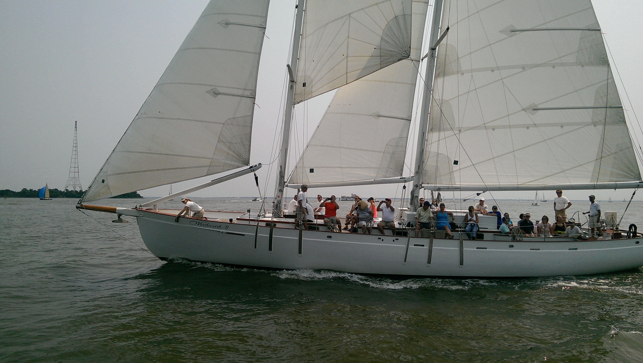 Guests waving as they sail by on the schooner