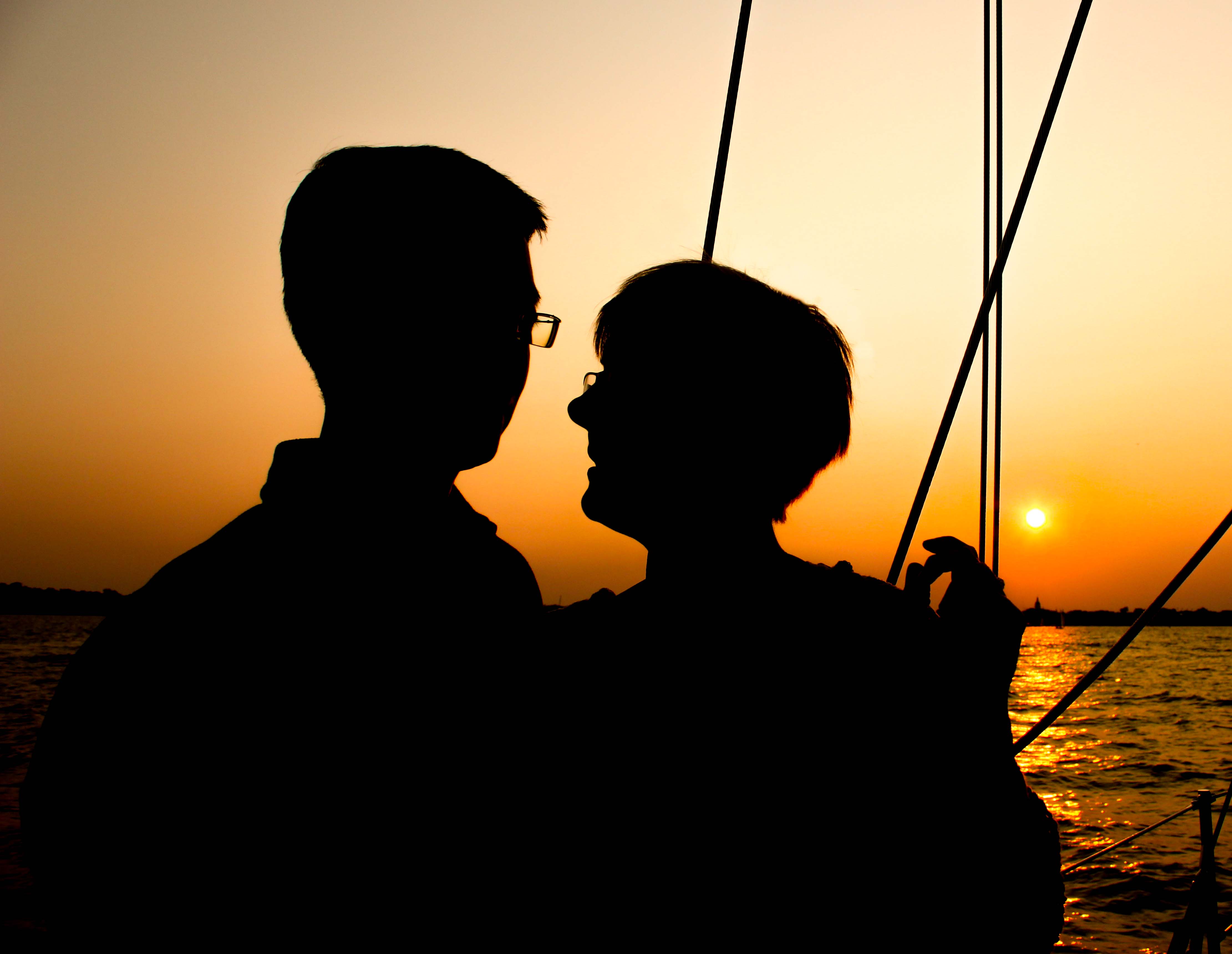 Couple enjoying sail at sunset