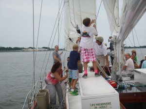 Kids helping raise the staysail