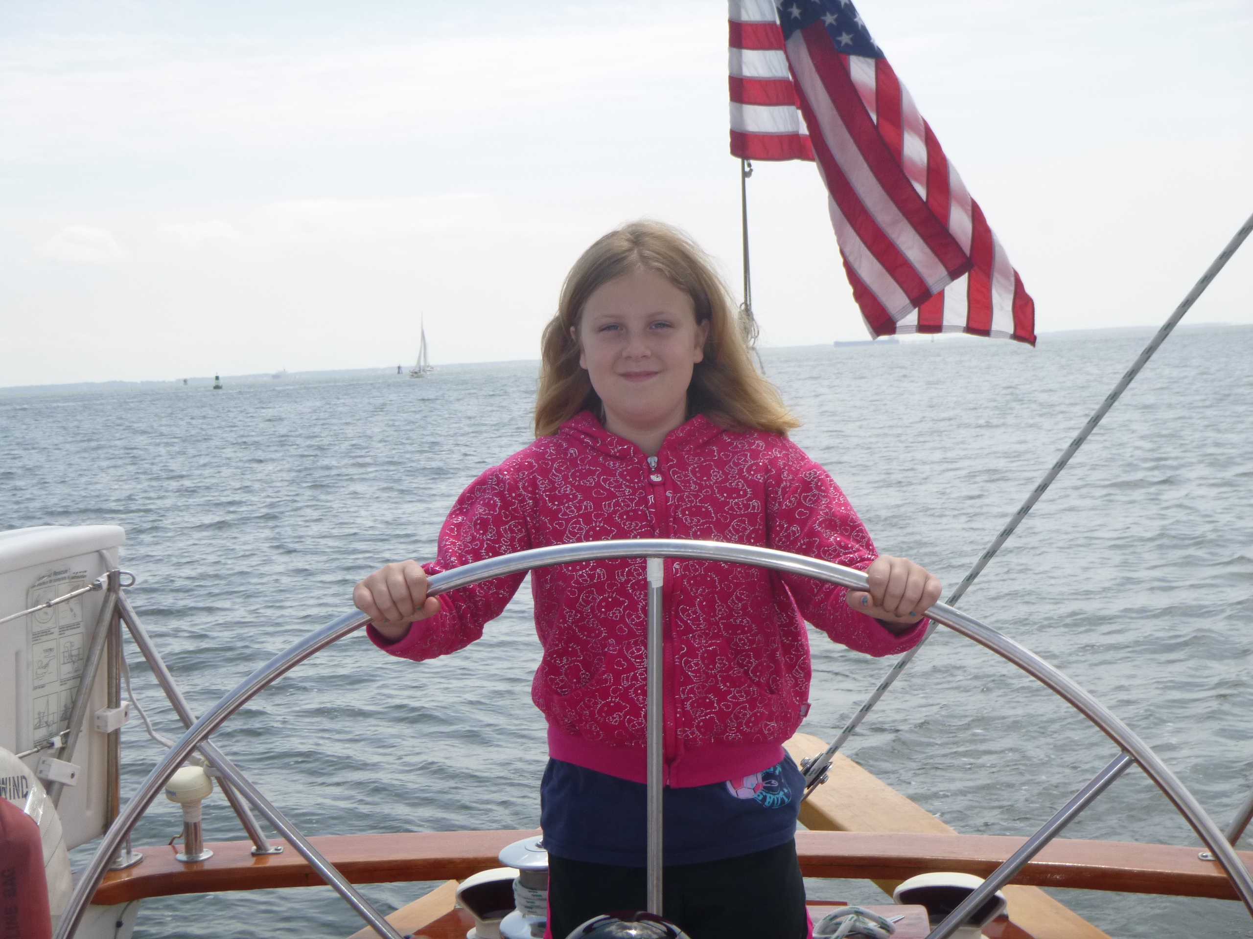 Erinn at the helm of the Schooner Woodwind