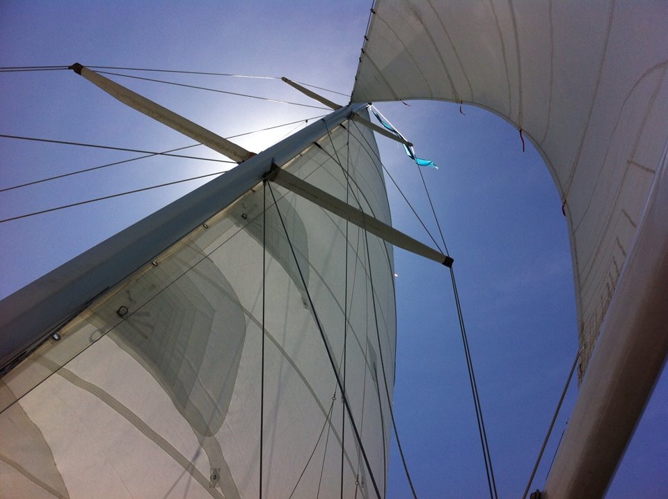 White Sails with blue sky and sun