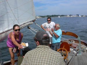 Captain Mark in light blue shirt, with Lisa feeding hungry James, while Ian watches patiently. 