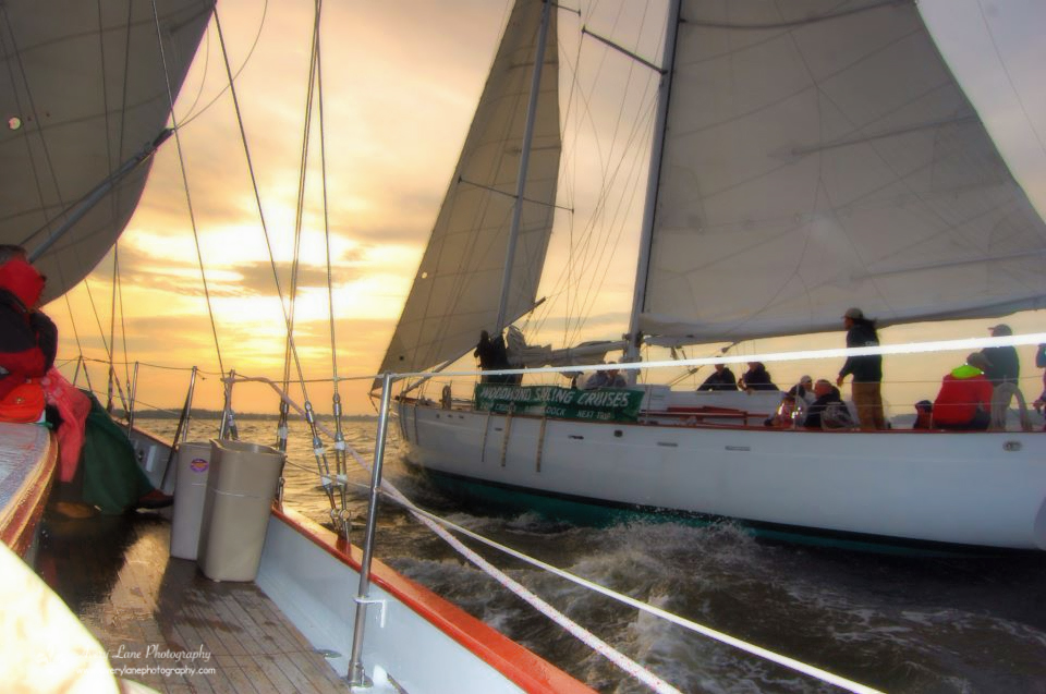 Schooner sailing side by side at sunset