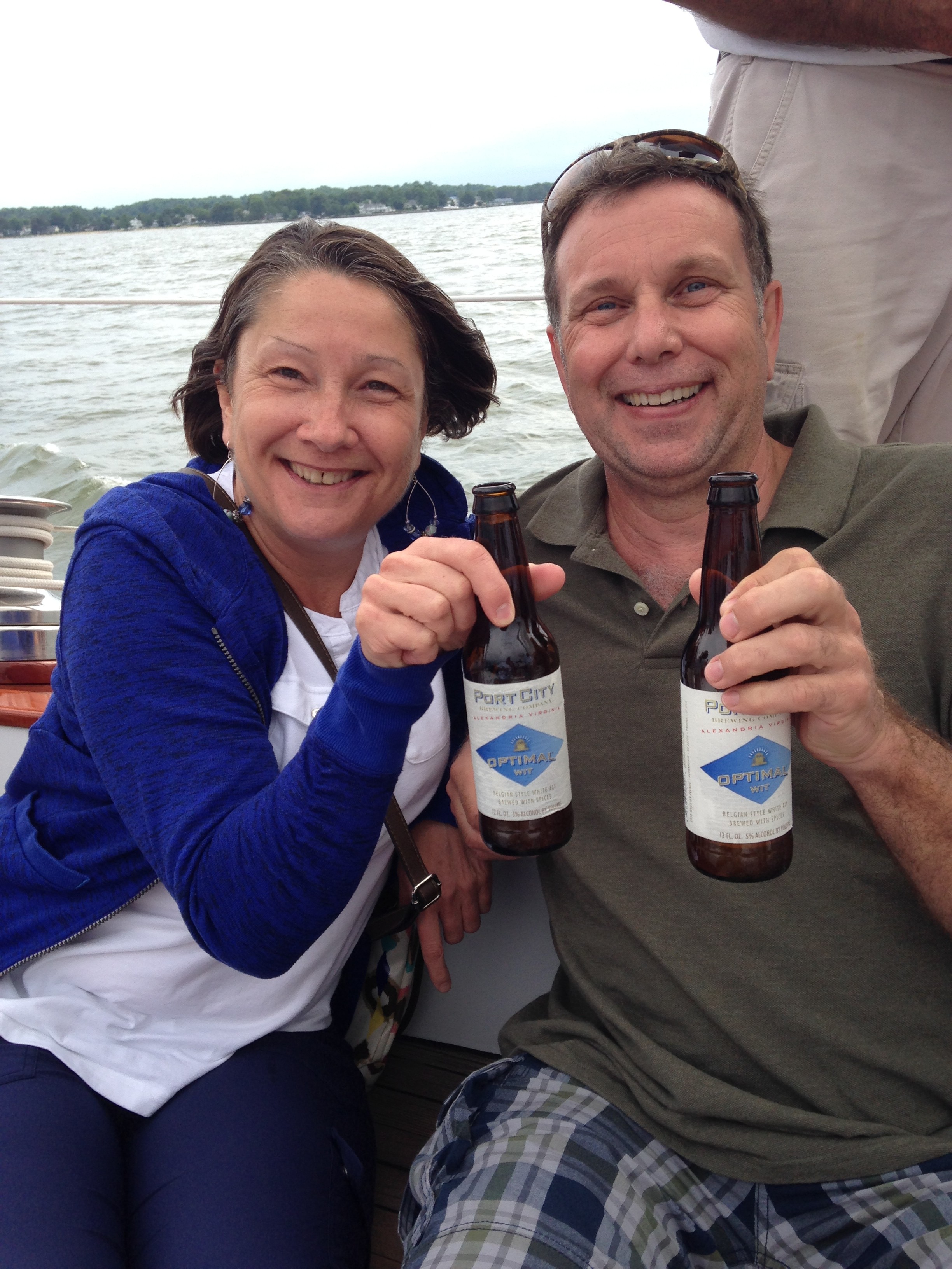 Two guests enjoying Port City beverages on a sail