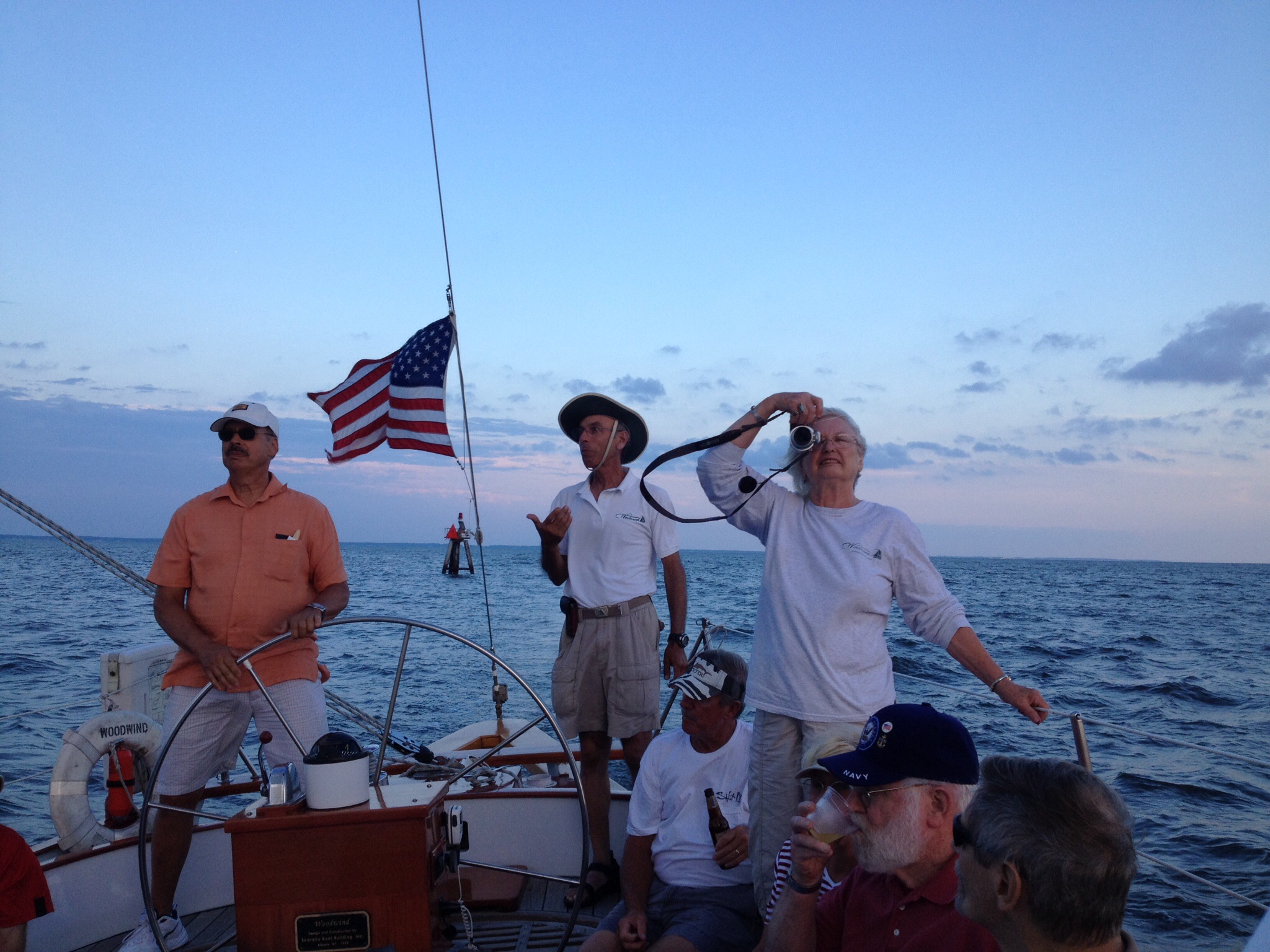 Guests steering the schooner with Captain looking on